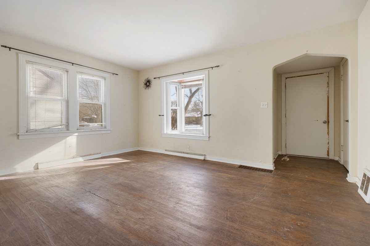 3310 186th Street Lansing, IL 60438 - Photo 3 of 19 an empty room with wooden floor and windows