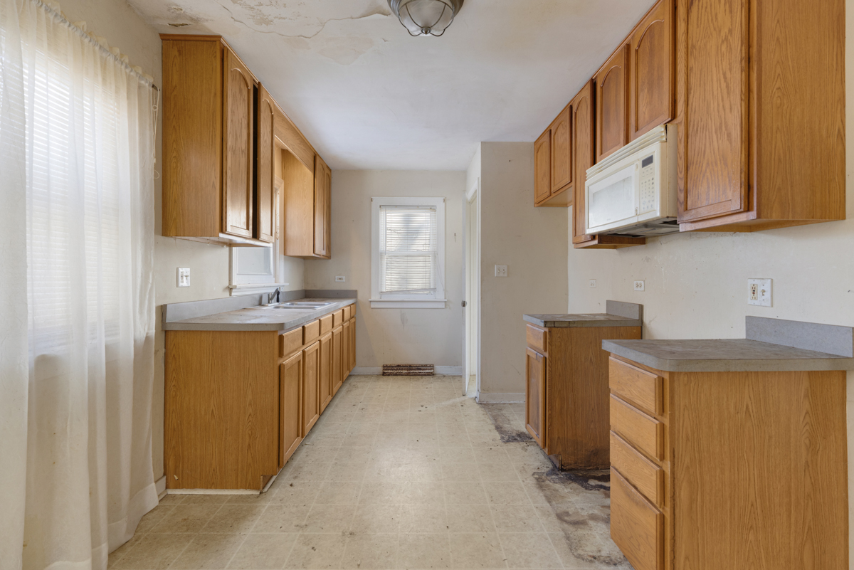 3310 186th Street Lansing, IL 60438 - Photo 8 of 19 a kitchen with stainless steel appliances granite countertop a sink and a refrigerator