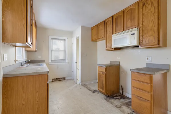 a kitchen with a stove microwave and cabinets