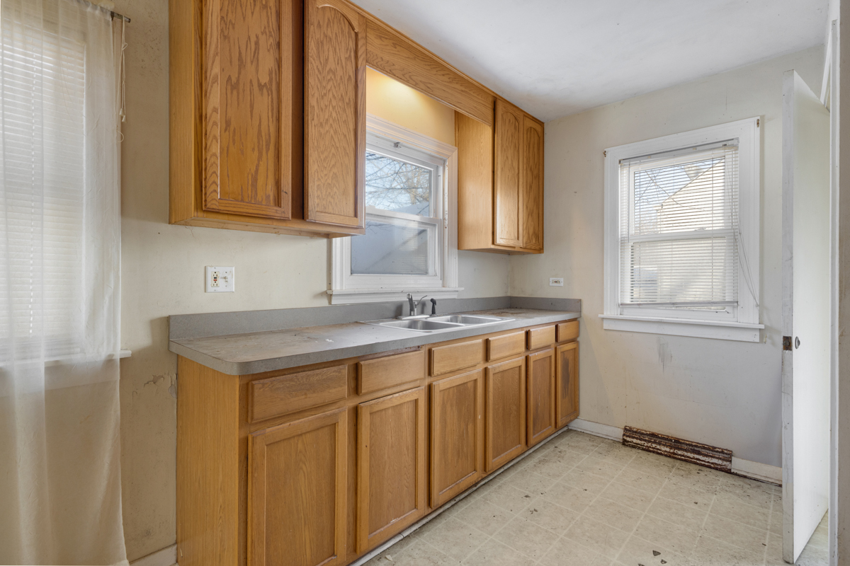 3310 186th Street Lansing, IL 60438 - Photo 10 of 19 a kitchen with stainless steel appliances granite countertop a sink and a window