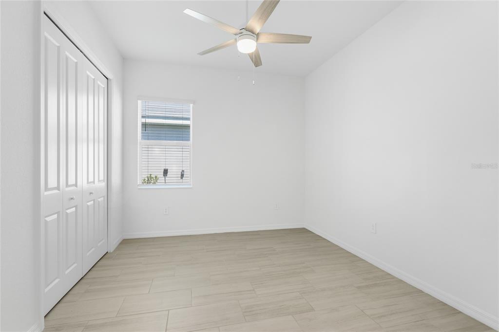 19156 Cherrystone Way Lakewood Ranch, FL 34211 - Photo 14 of 49 an empty room with a window and ceiling fan