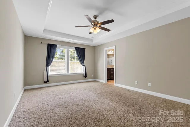 a view of a livingroom with a ceiling fan and window