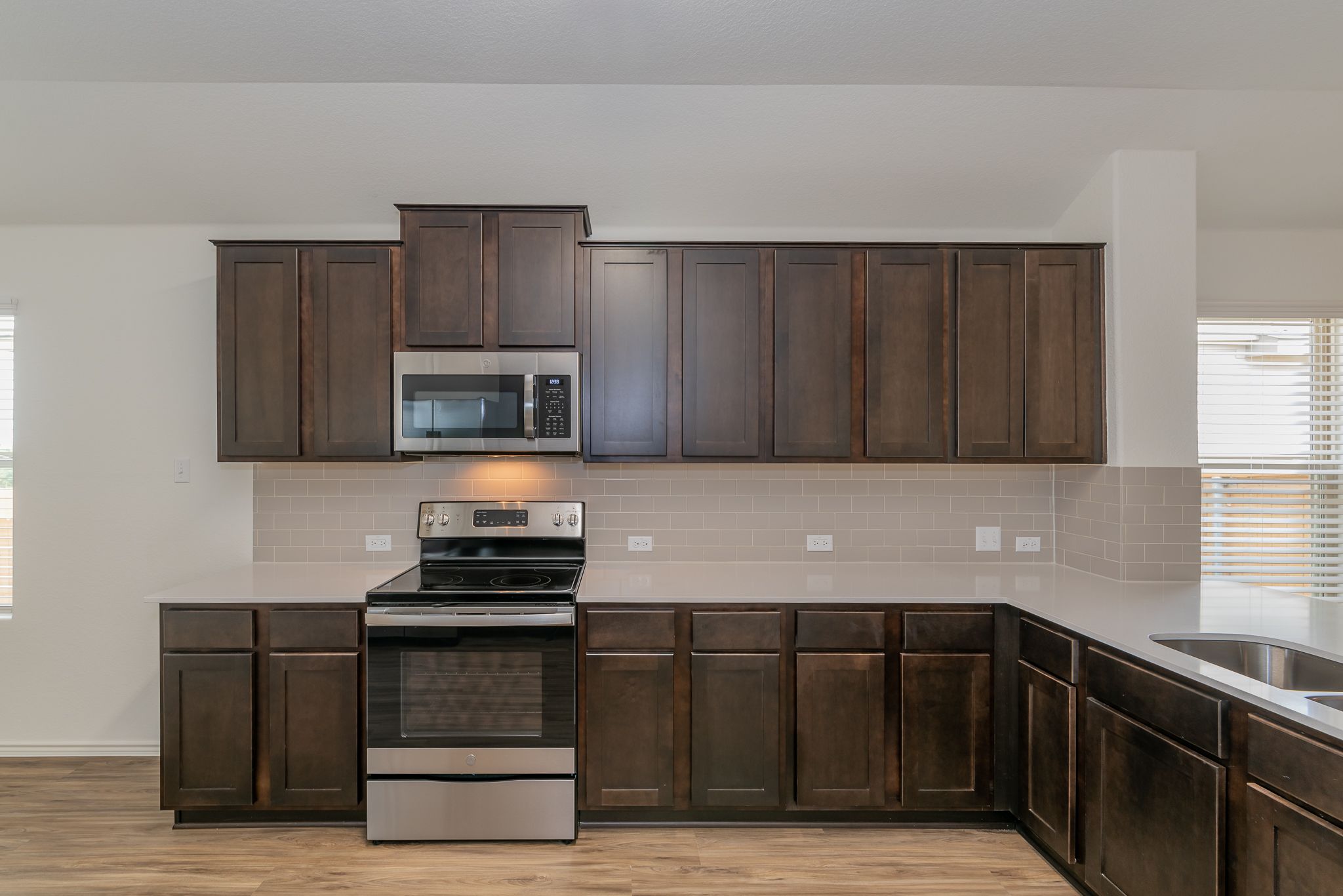 509 Greatest Gift Way Jarrell, TX 76537 - Photo 9 of 28 a kitchen with granite countertop wooden cabinets and black appliances