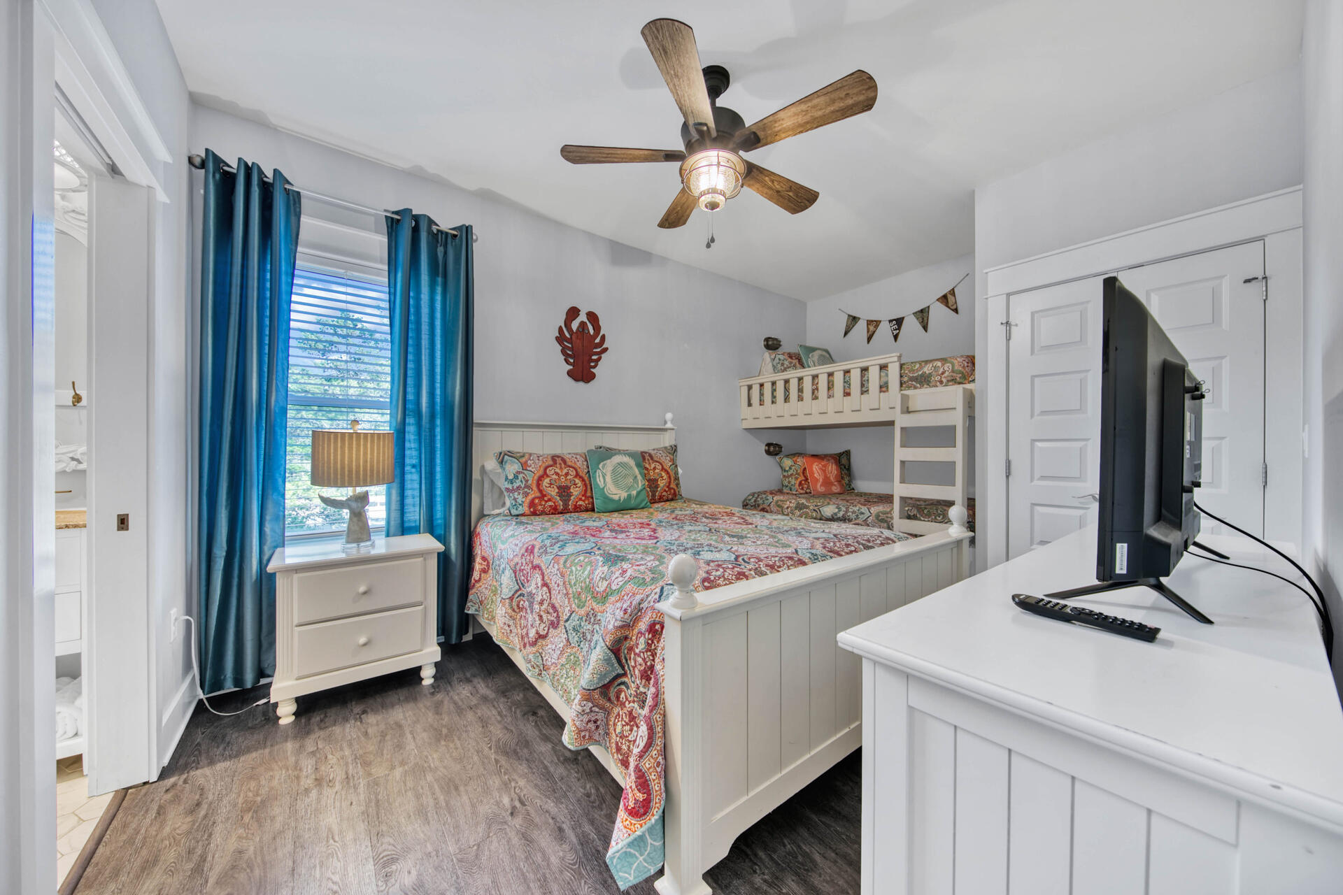 56 Abbey Road Santa Rosa Beach, FL 32459 - Photo 20 of 40 a bedroom with a large bed and a chandelier
