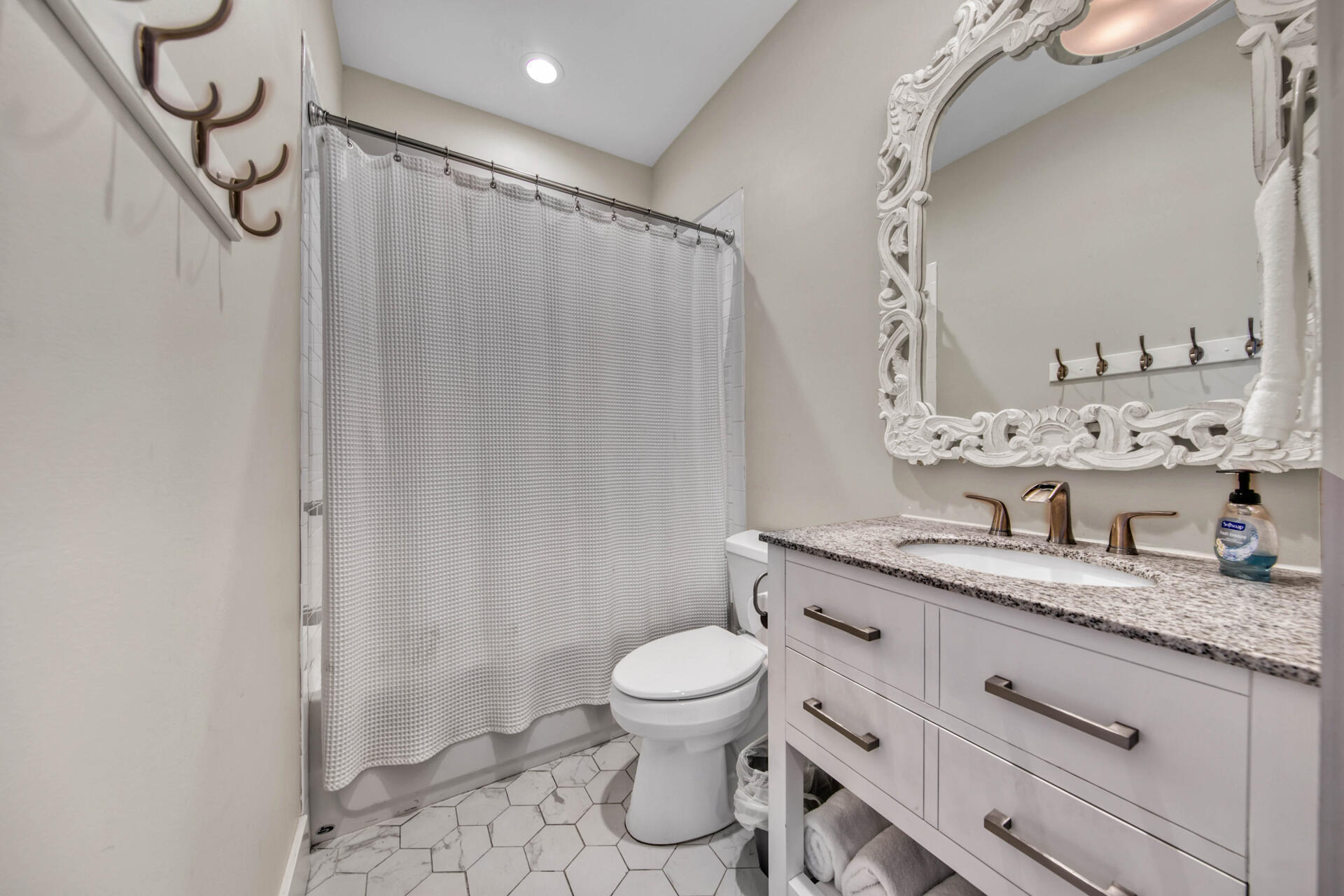 56 Abbey Road Santa Rosa Beach, FL 32459 - Photo 22 of 40 a bathroom with a granite countertop sink toilet a mirror a vanity and shower