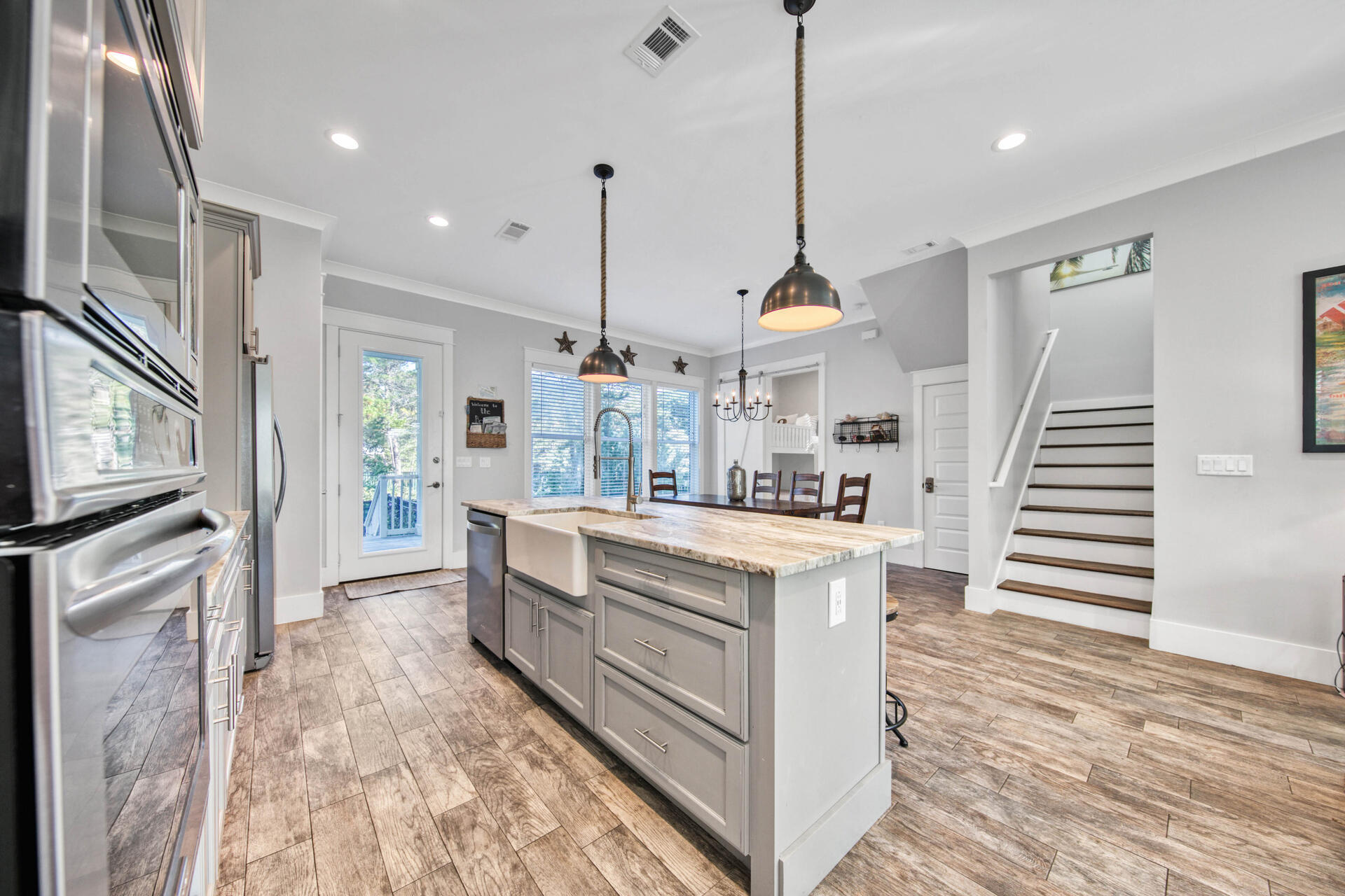 56 Abbey Road Santa Rosa Beach, FL 32459 - Photo 9 of 40 a kitchen with stainless steel appliances kitchen island granite countertop a stove a sink and a wooden floor