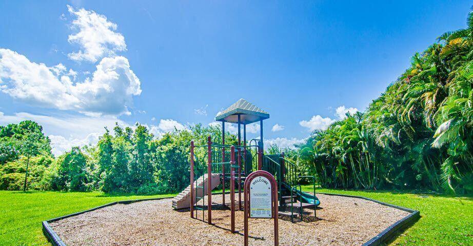 118 Southwest Peacock Boulevard, Unit 10202 Port St. Lucie, FL 34986 - Photo 11 of 11 a view of a slide in a backyard