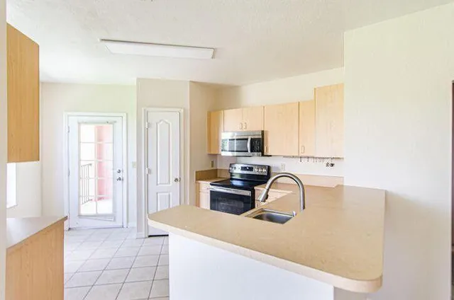 a view of a kitchen with a sink cabinets and a window
