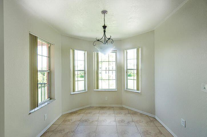 118 Southwest Peacock Boulevard, Unit 10202 Port St. Lucie, FL 34986 - Photo 5 of 11 a view of an empty room with a window