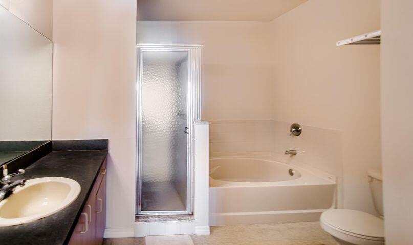 118 Southwest Peacock Boulevard, Unit 10202 Port St. Lucie, FL 34986 - Photo 6 of 11 a bathroom with a sink toilet and shower