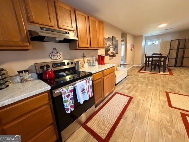 226 Lake Laurel Road Milledgeville, GA 31061 - Photo 13 of 25 a kitchen with stainless steel appliances granite countertop a stove a sink dishwasher and cabinets with wooden floor