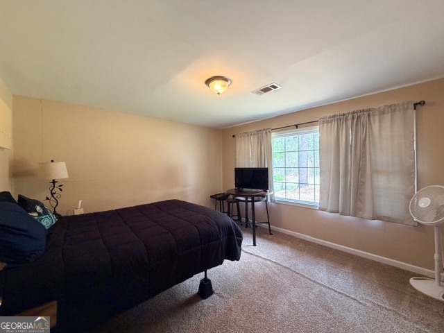 226 Lake Laurel Road Milledgeville, GA 31061 - Photo 15 of 25 a spacious bedroom with a bed and a window