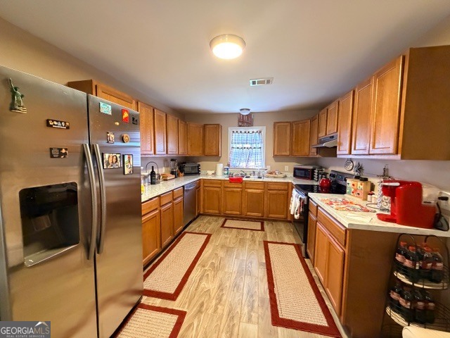 226 Lake Laurel Road Milledgeville, GA 31061 - Photo 16 of 25 a kitchen with stainless steel appliances granite countertop a refrigerator a stove top oven a sink and dishwasher