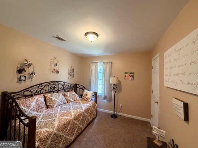 226 Lake Laurel Road Milledgeville, GA 31061 - Photo 17 of 25 a bedroom with a bed and a painting on the wall