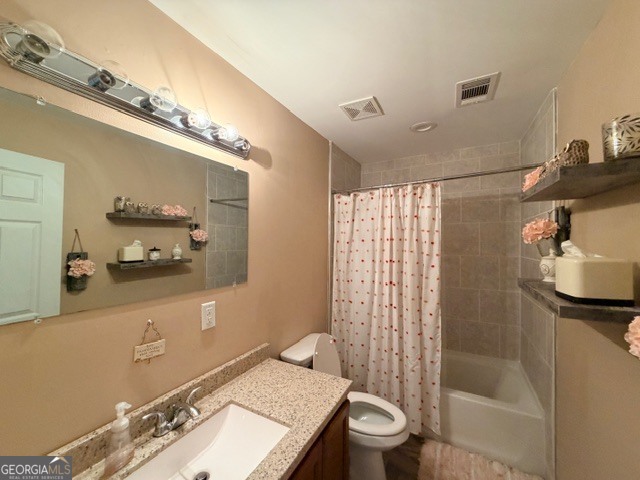 226 Lake Laurel Road Milledgeville, GA 31061 - Photo 18 of 25 a bathroom with a granite countertop sink a toilet a mirror and shower