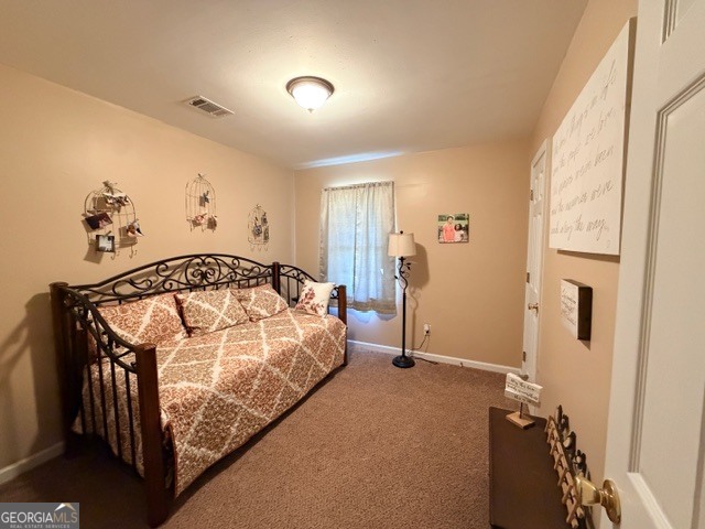 226 Lake Laurel Road Milledgeville, GA 31061 - Photo 22 of 25 a bedroom with a bed and a window