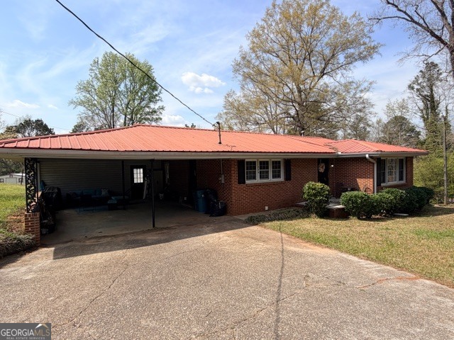 226 Lake Laurel Road Milledgeville, GA 31061 - Photo 25 of 25 a front view of a house with a yard and garage