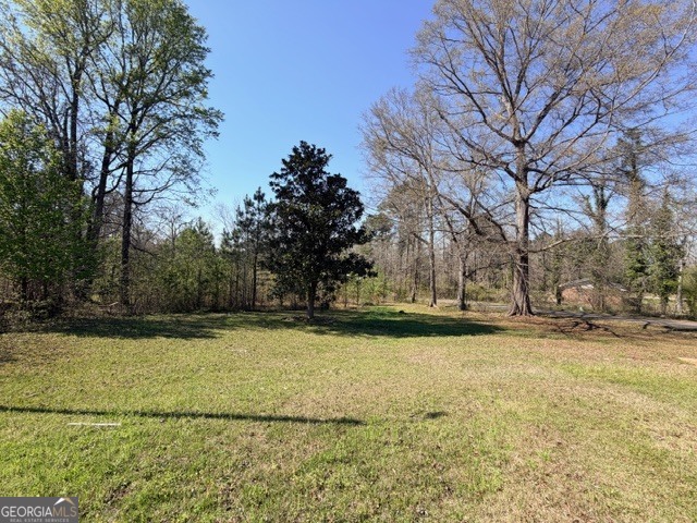 226 Lake Laurel Road Milledgeville, GA 31061 - Photo 4 of 25 a view of a swimming pool and trees in the background