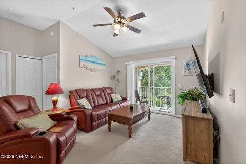 a living room with furniture and a large window