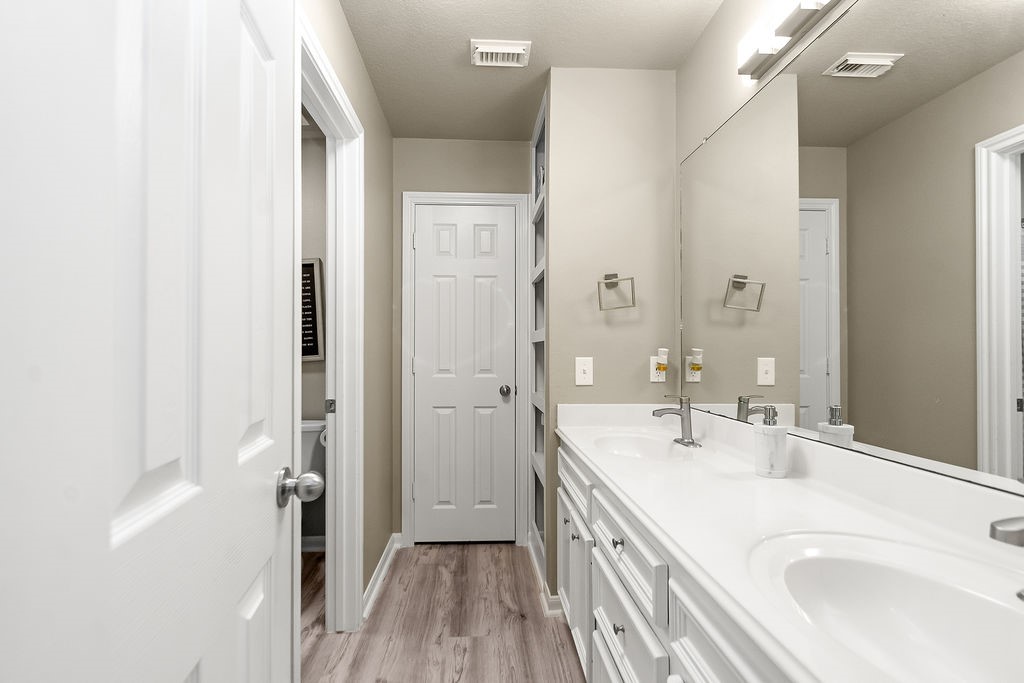 222 Doncaster Street Conroe, TX 77303 - Photo 16 of 33 a bathroom with a sink a mirror and a shower