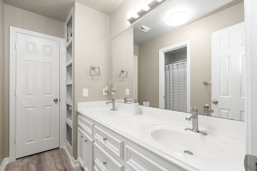222 Doncaster Street Conroe, TX 77303 - Photo 17 of 33 a bathroom with a sink and a mirror