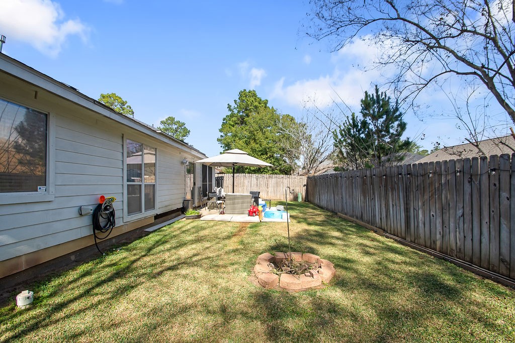 222 Doncaster Street Conroe, TX 77303 - Photo 31 of 33 a view of a backyard with a sitting area