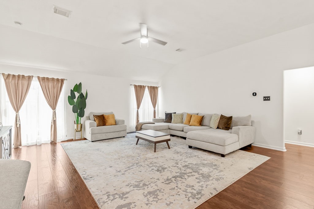 222 Doncaster Street Conroe, TX 77303 - Photo 7 of 33 a living room with furniture and wooden floor