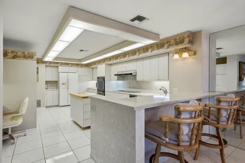 a bedroom with a bed and large windows