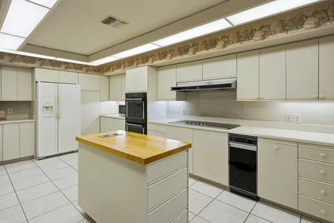 a kitchen with a stove a sink and a refrigerator