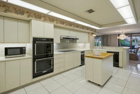 a kitchen with a stove sink and refrigerator