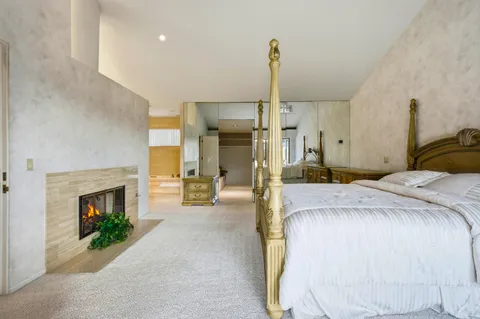 a bedroom with a bed and a fireplace