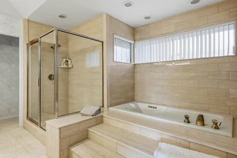 a bathroom with a bathtub and a shower
