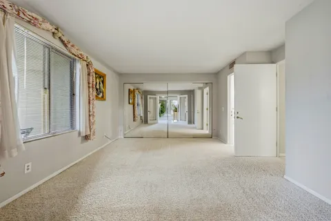 a view of a big room with closet and windows