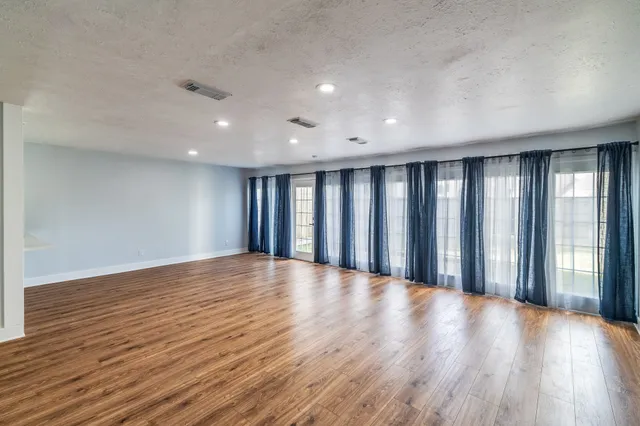 a view of wooden floor and windows in a room