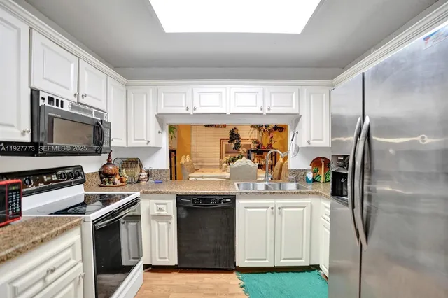 a kitchen with a sink stove and refrigerator