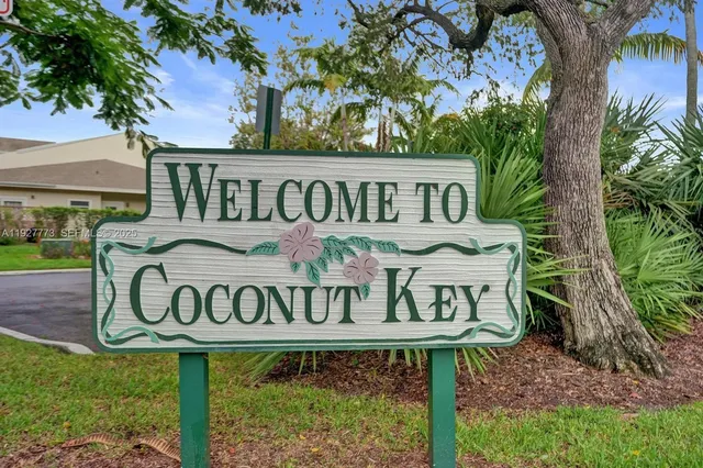 a view of a street sign under a large tree