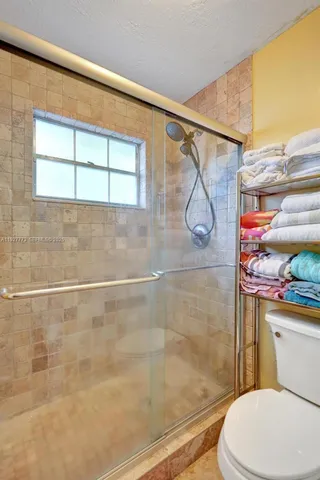 a white toilet sitting next to a bathroom sink