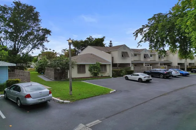a couple of cars parked in front of a house