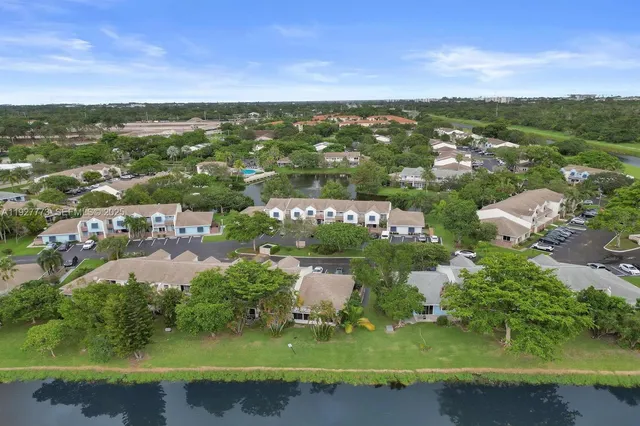 an aerial view of residential houses with outdoor space and river