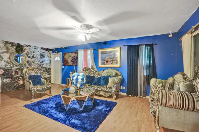 a living room with furniture a rug and a chandelier