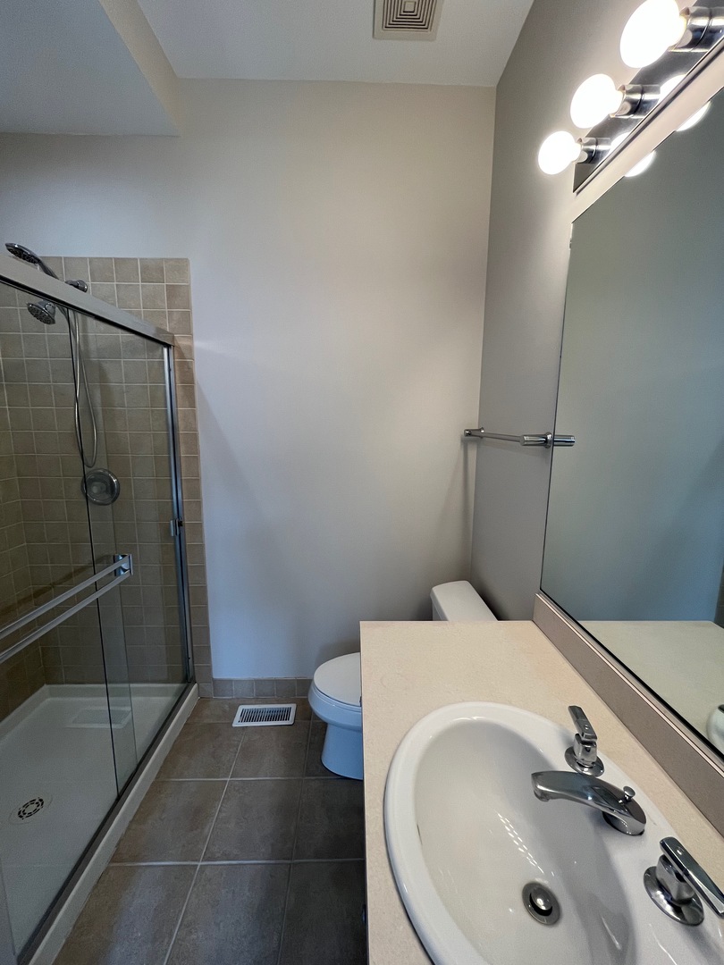 1246 West Cottage Place Chicago, IL 60607 - Photo 8 of 16 a bathroom with a sink and a mirror
