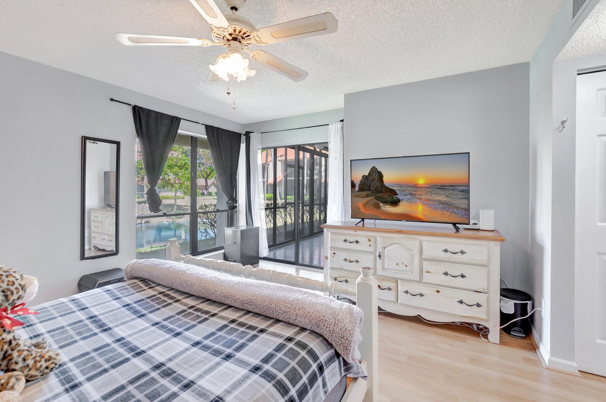 5731 Coach House Circle, Unit A Boca Raton, FL 33486 - Photo 21 of 44 PRIMARY WITH SLIDER TO PATIO