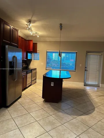 a kitchen with granite countertop a stove and a microwave
