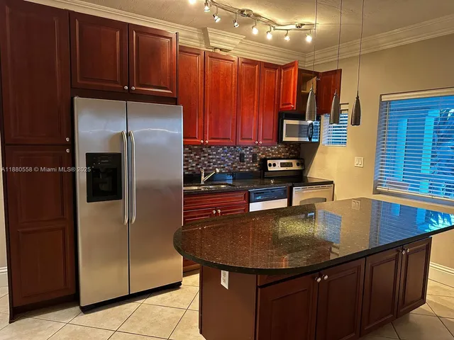 an empty room with wooden floor closet and windows