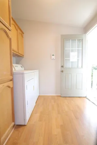 a view of empty room with wooden floor and cabinet