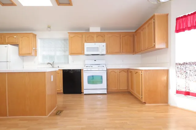 a kitchen with stainless steel appliances granite countertop a sink and a stove top oven