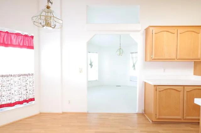 a kitchen with a sink a stove and cabinets