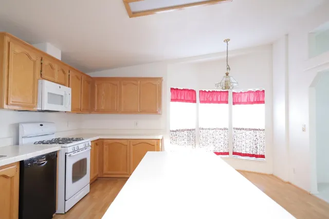 a kitchen with a sink a stove and a wooden cabinets