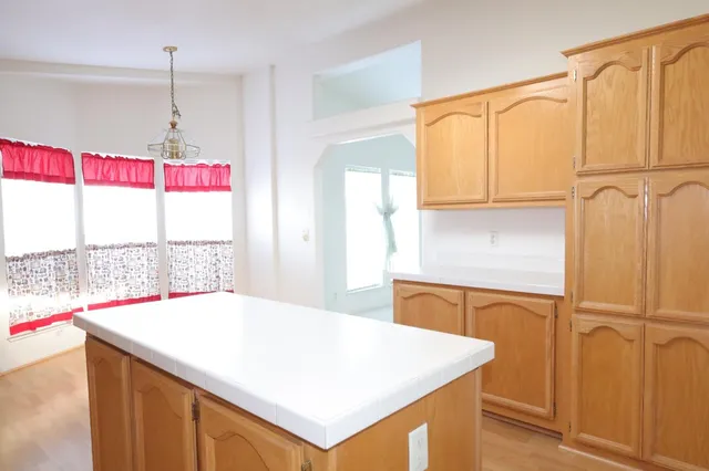 a kitchen with stainless steel appliances granite countertop a sink a stove and a refrigerator