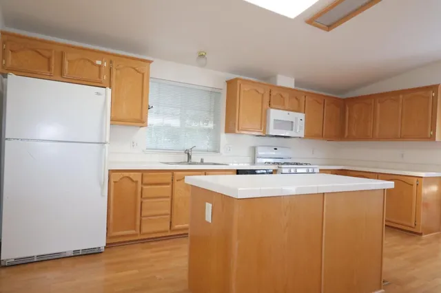 a kitchen with stainless steel appliances a sink stove and cabinets